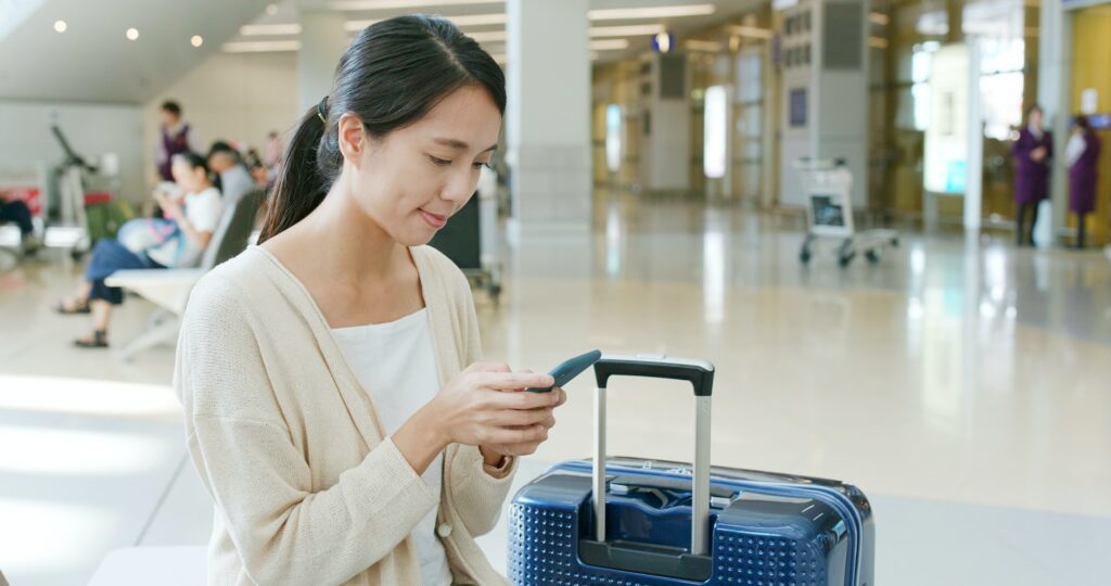 Woman use of mobile phone in airport